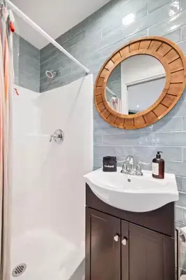 a bathroom with a sink and a mirror at Ocean Views Steps to Beach Rooftop Firepit in San Diego