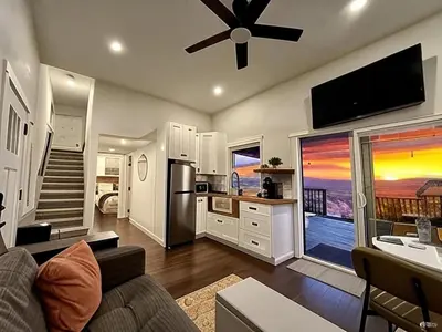 a living room with a kitchen with a large window at The Hilltop Haven - Private View Suite in Temecula