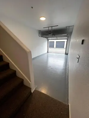 an empty room with stairs and a stair case at Cozy Luxurious Spacious Apt with Valley View, Attached Garage,Pool,24-Hour Gym, 3 TV in Mission Viejo