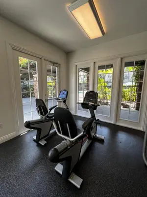 a gym with three chairs and a laptop in it at Cozy Luxurious Spacious Apt with Valley View, Attached Garage,Pool,24-Hour Gym, 3 TV in Mission Viejo
