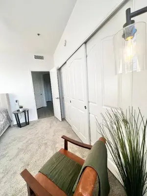 a living room with a couch and a table at Cozy Luxurious Spacious Apt with Valley View, Attached Garage,Pool,24-Hour Gym, 3 TV in Mission Viejo