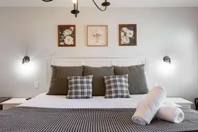 a bedroom with a large bed with two pillows at 10 min to Beach Central Villa in San Diego
