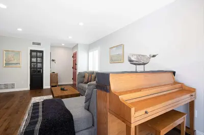a living room with a couch and a piano at 10 min to Beach Central Villa in San Diego