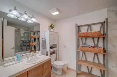 a bathroom with a sink and a toilet and a mirror at Gaslamp District Heart of San Diego in San Diego