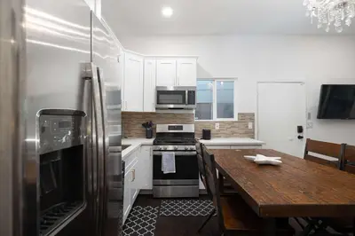 a kitchen with a wooden table and a refrigerator at Ocean Views 2 Kitchen Living area Villa in San Diego