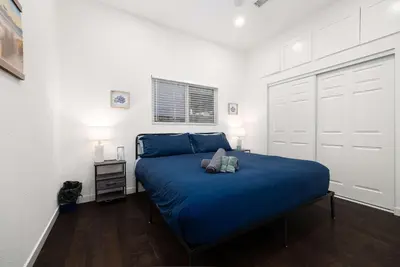 a bedroom with a blue bed in a white room at Ocean Views 2 Kitchen Living area Villa in San Diego