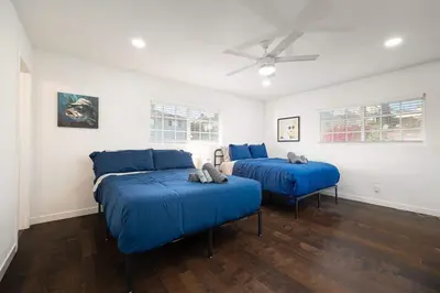 a bedroom with two beds and a ceiling fan at Ocean Views 2 Kitchen Living area Villa in San Diego