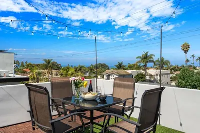 a table and chairs on a patio with a view at Seaside Spiral in San Diego