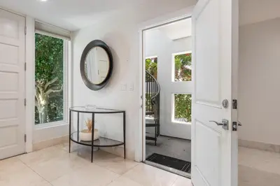 a hallway with a mirror and a glass table at Seaside Spiral in San Diego
