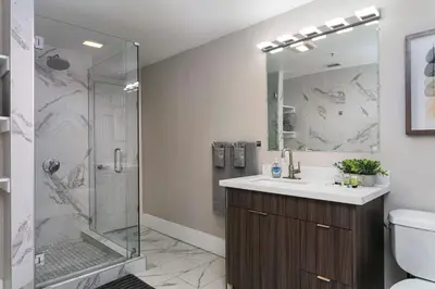 a bathroom with a shower and a sink at The Historic Penn Hotel in San Diego