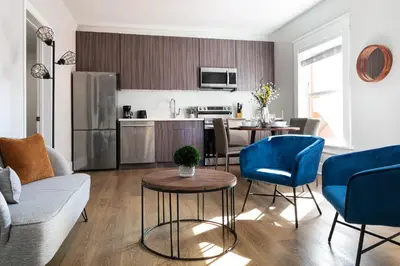 a kitchen and living room with a couch and a table at The Historic Penn Hotel in San Diego