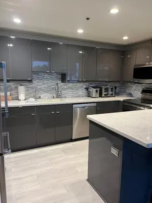 a kitchen with black cabinets and stainless steel appliances at Sail Bay Condo in PB Bay View close to the Ocean! 30 day stay is required in San Diego