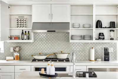 a kitchen with white cabinets and a stove top oven at Luxury Oasis Resort Pool&Spa Fitness Arcade in Ladera Ranch