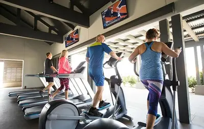 a group of people exercising on treadmills in a gym at Luxury Oasis Resort Pool&Spa Fitness Arcade in Ladera Ranch
