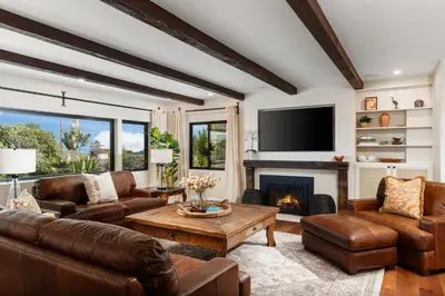 a living room with leather furniture and a fireplace at Luxury Point Loma Retreat Pool Spa Views in San Diego