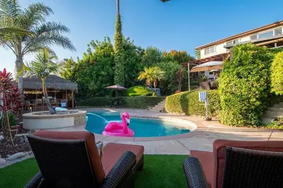 a swimming pool with a pink flamingo in a yard at Luxury Bayview Oasis • Pool Spa Games Views in San Diego