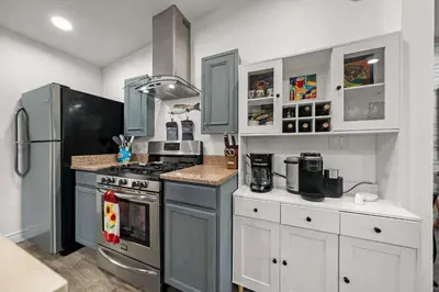 a kitchen with a stove and a refrigerator at 2br Pet-Friendly Oceanside Home in Oceanside