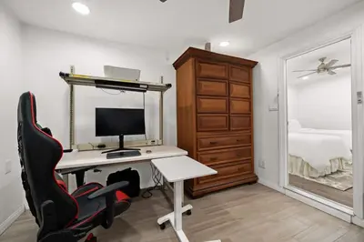a bedroom with a desk with a computer and a bed at 2br Pet-Friendly Oceanside Home in Oceanside