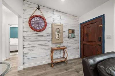 a room with a wall with a clock and a table at 2br Pet-Friendly Oceanside Home in Oceanside