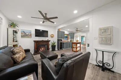 a living room with leather furniture and a fireplace at 2br Pet-Friendly Oceanside Home in Oceanside