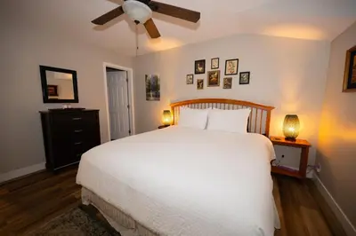 a bedroom with a white bed and a ceiling fan at Beach Home in Quiet Neighborhood 5 minutes from the Pier in Oceanside