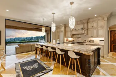 a kitchen with a large island with bar stools at Elegant La Jolla Villa - Ocean Views & Pool in San Diego
