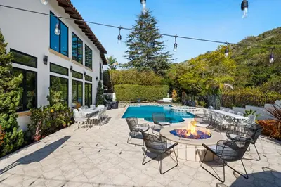 a patio with a fire pit and chairs and a pool at Elegant La Jolla Villa - Ocean Views & Pool in San Diego