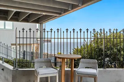 a table and chairs on a balcony with a view of the ocean at New Modern Studio - Stunning Ocean view in San Diego