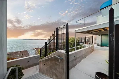 a view of the water from a house with a fence at New Modern Studio - Stunning Ocean view in San Diego