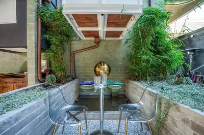 a patio with a table and chairs and plants at Hotel Narcissus - Room 1 in San Diego