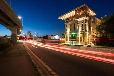 a city street with a building and streaks of lights at Hotel Narcissus - Room 3 in San Diego