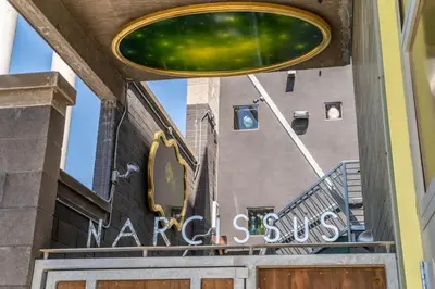 a sign for a market store in front of a building at Hotel Narcissus - Room 5 in San Diego