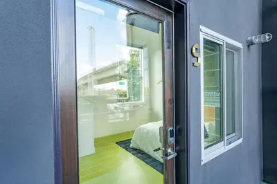 a door to a bedroom with a bed and a window at Hotel Narcissus - Room 6 in San Diego