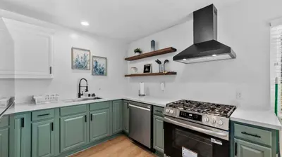 a kitchen with green cabinets and a stove top oven at Stylish Apartments in Mission Hills with Outdoor Space in San Diego