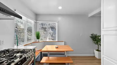 a kitchen with a stove and a wooden table at Stylish Apartments in Mission Hills with Outdoor Space in San Diego