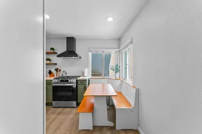 a kitchen with a wooden table and a stove at Stylish Apartments in Mission Hills with Outdoor Space in San Diego