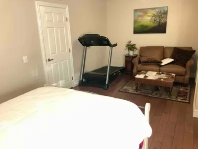 a bedroom with a room with a treadmill and a couch at San Diego Paradise - Scenic Views, Pool and Spa in El Cajon