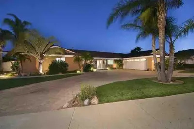 a house with palm trees and a driveway at San Diego Paradise - Scenic Views, Pool and Spa in El Cajon