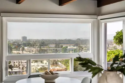 a large window in a living room with a view of the city at NEW Cozy Modern Home with Hot Tub and Ocean Views in San Diego