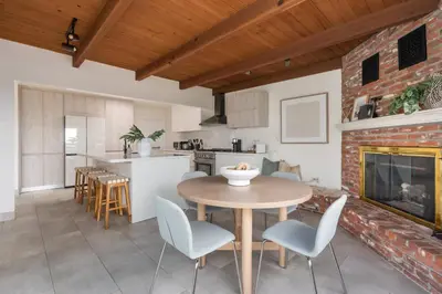 a kitchen and living room with a table and chairs at NEW Cozy Modern Home with Hot Tub and Ocean Views in San Diego