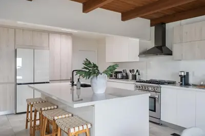 a kitchen with a island with a potted plant on it at NEW Cozy Modern Home with Hot Tub and Ocean Views in San Diego