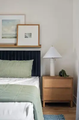a bedroom with a bed and a table with a lamp at NEW Cozy Modern Home with Hot Tub and Ocean Views in San Diego