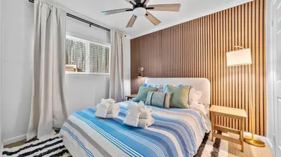 a bedroom with a bed with a ceiling fan at Chic San Diego Apartment with Hot Tub & Workspace in San Diego