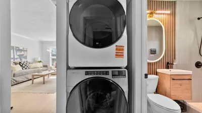a washer and dryer in a living room at Chic San Diego Apartment with Hot Tub & Workspace in San Diego