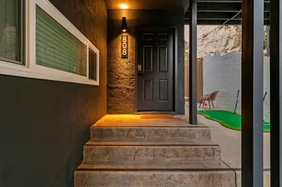 a front door of a house with stairs and a light at Chic San Diego Apartment with Hot Tub & Workspace in San Diego