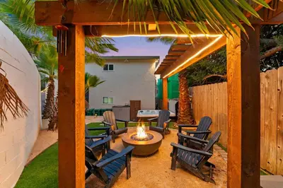 an outdoor patio with chairs and a fire pit at Chic San Diego Apartment with Hot Tub & Workspace in San Diego