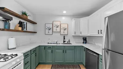 a kitchen with green cabinets and a sink at Cozy San Diego Hideaway in Historic Mission Hills in San Diego