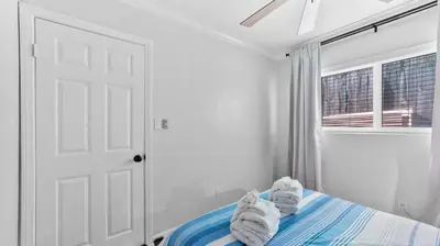 a bedroom with white walls and a bed with towels at Cozy San Diego Hideaway in Historic Mission Hills in San Diego