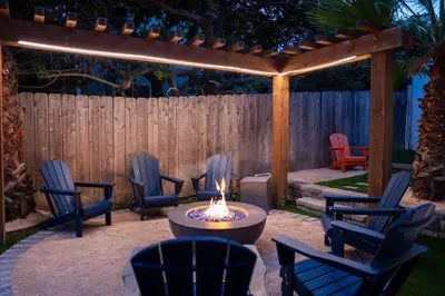 a fire pit in a backyard with chairs and a fence at Cozy San Diego Hideaway in Historic Mission Hills in San Diego