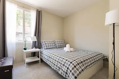 a small bedroom with a bed and a window at Relax and Recharge here Close to All Attractions in San Diego